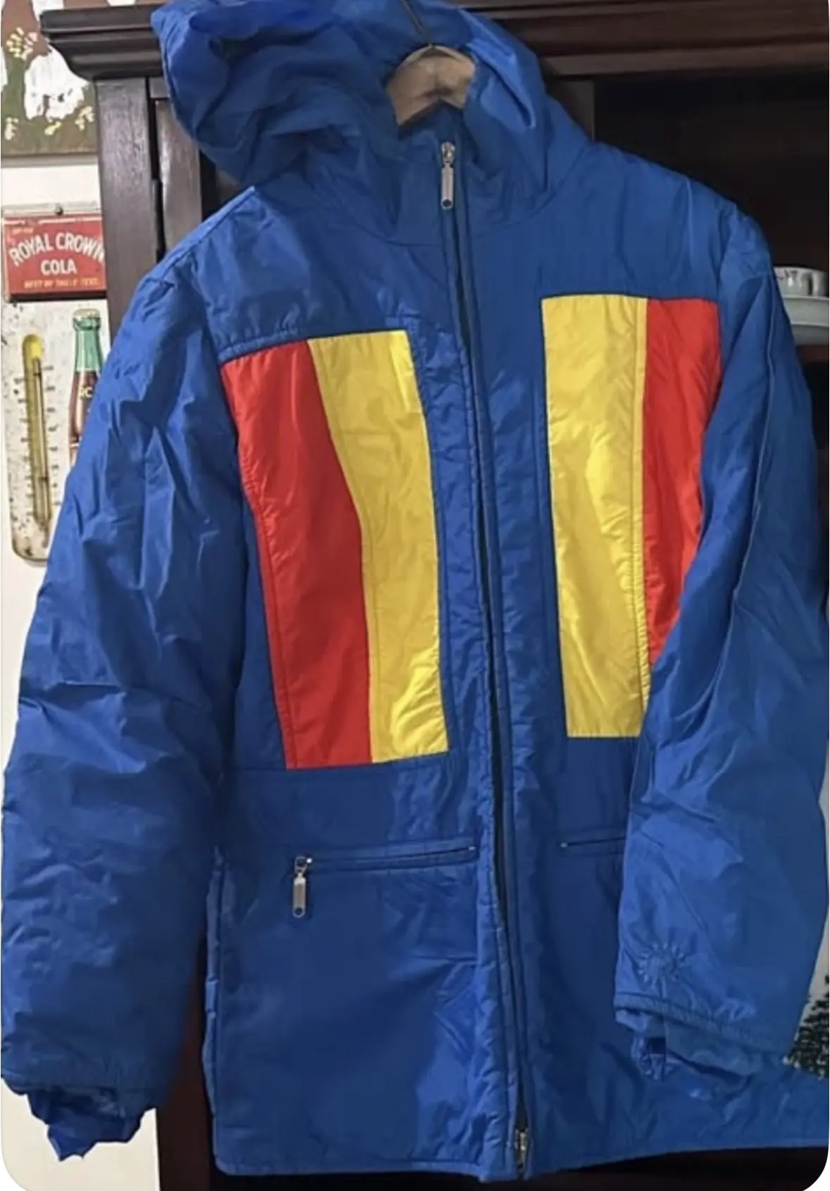 Royal-blue hooded jacket with bright yellow and red vertical color-block panels