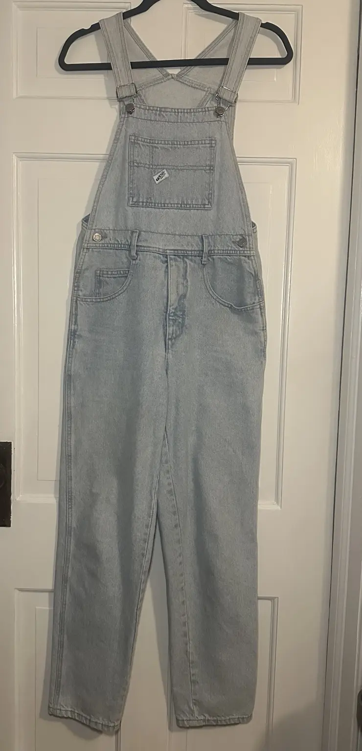 Front view of light-wash GUESS denim overalls