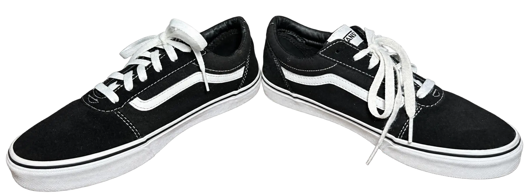 Transparent-background angled pair of black and white Vans low-top shoes