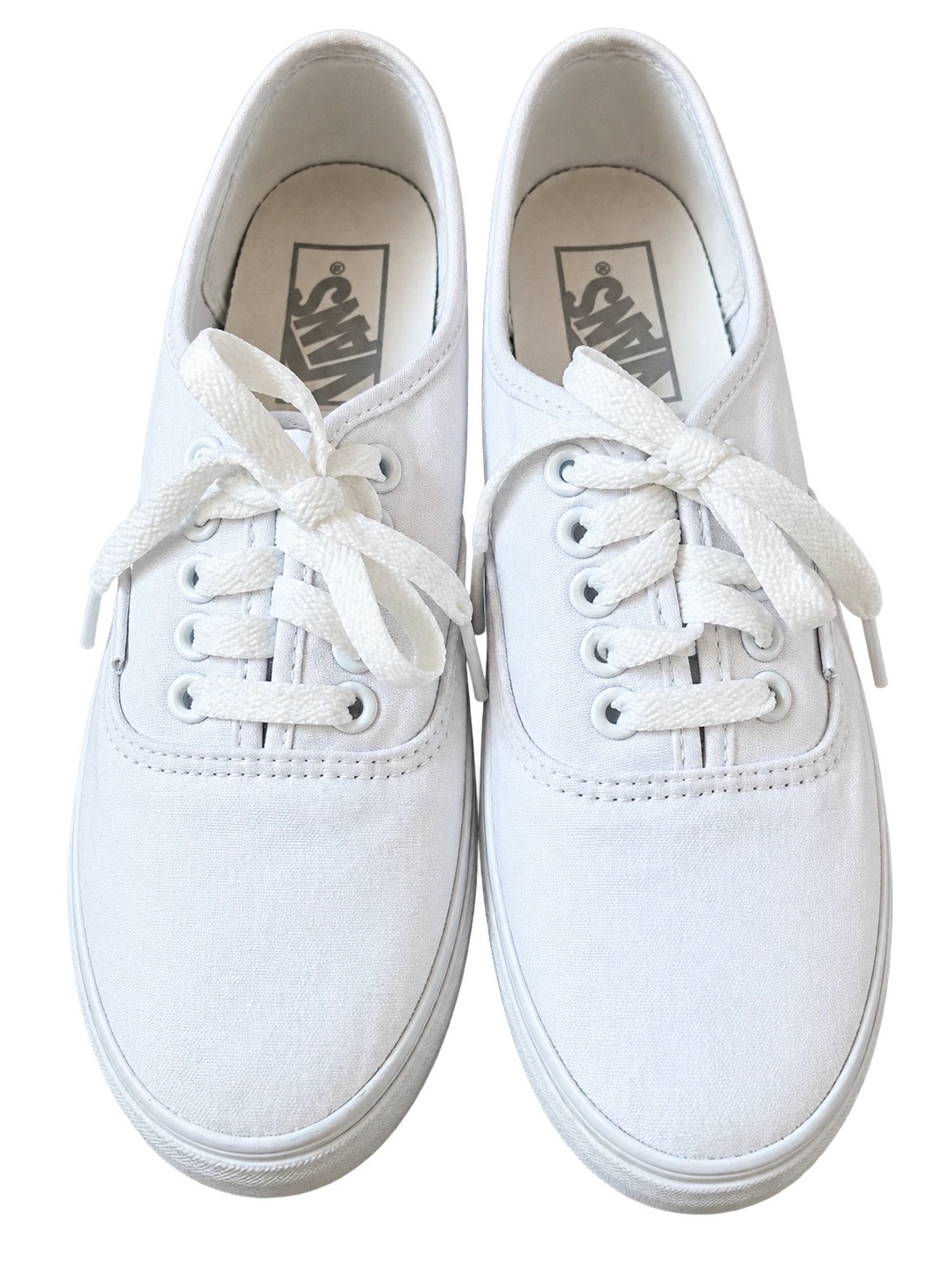Front view of white Vans sneakers